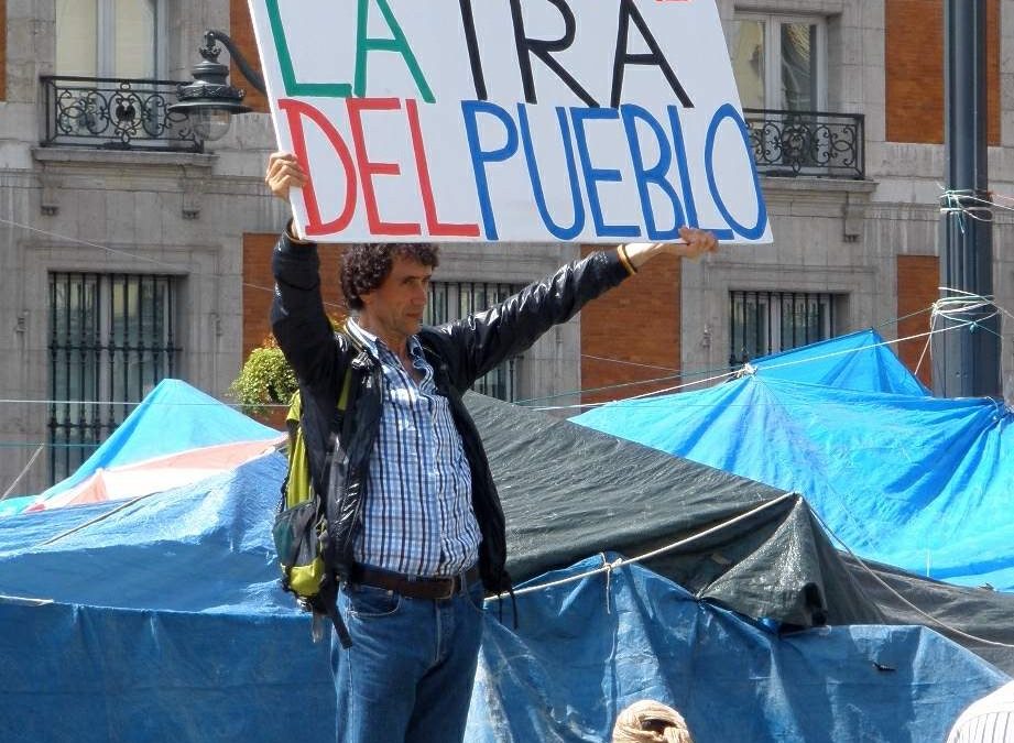 Man standing on street with placard.